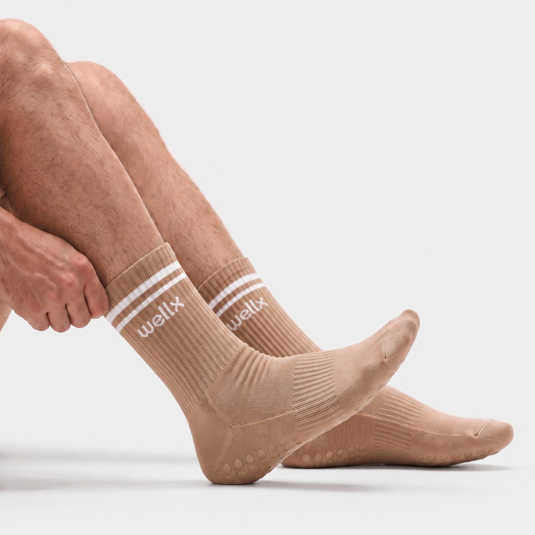Gravel Balance Grip Socks For Men with non-slip silicone grip sole, ribbed crew knit and white double-stripe cuff, shown from the side