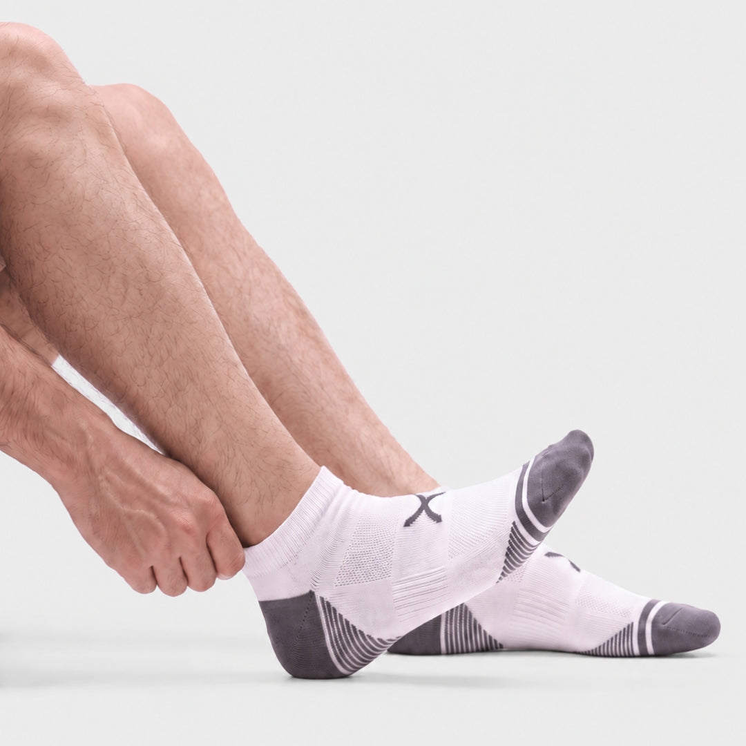 White Power Stride Ankle Socks For Men, Men's white ankle compression socks with grey toe and heel, breathable mesh knit and arch support, shown from the side