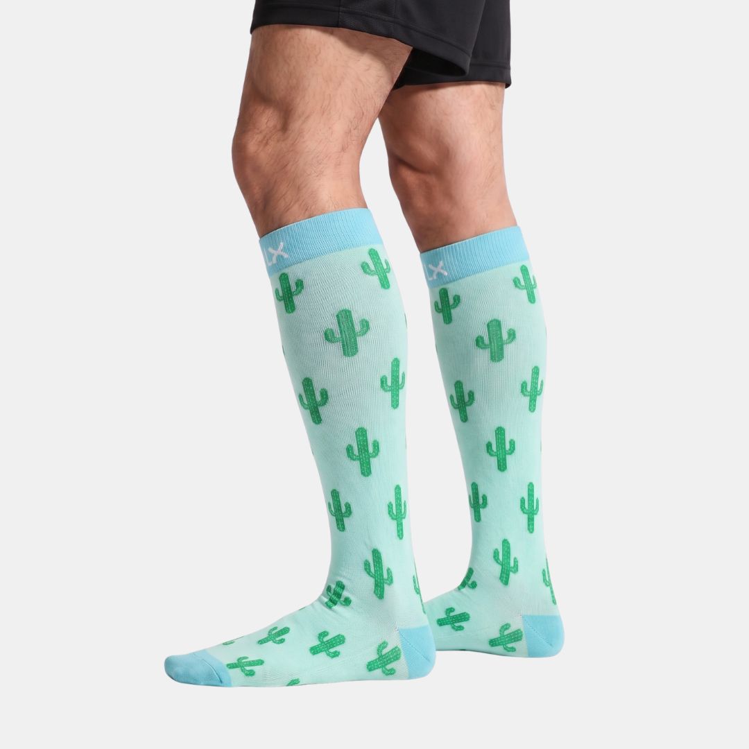 Cactus Green Compression Socks For Men worn with black shorts, side view