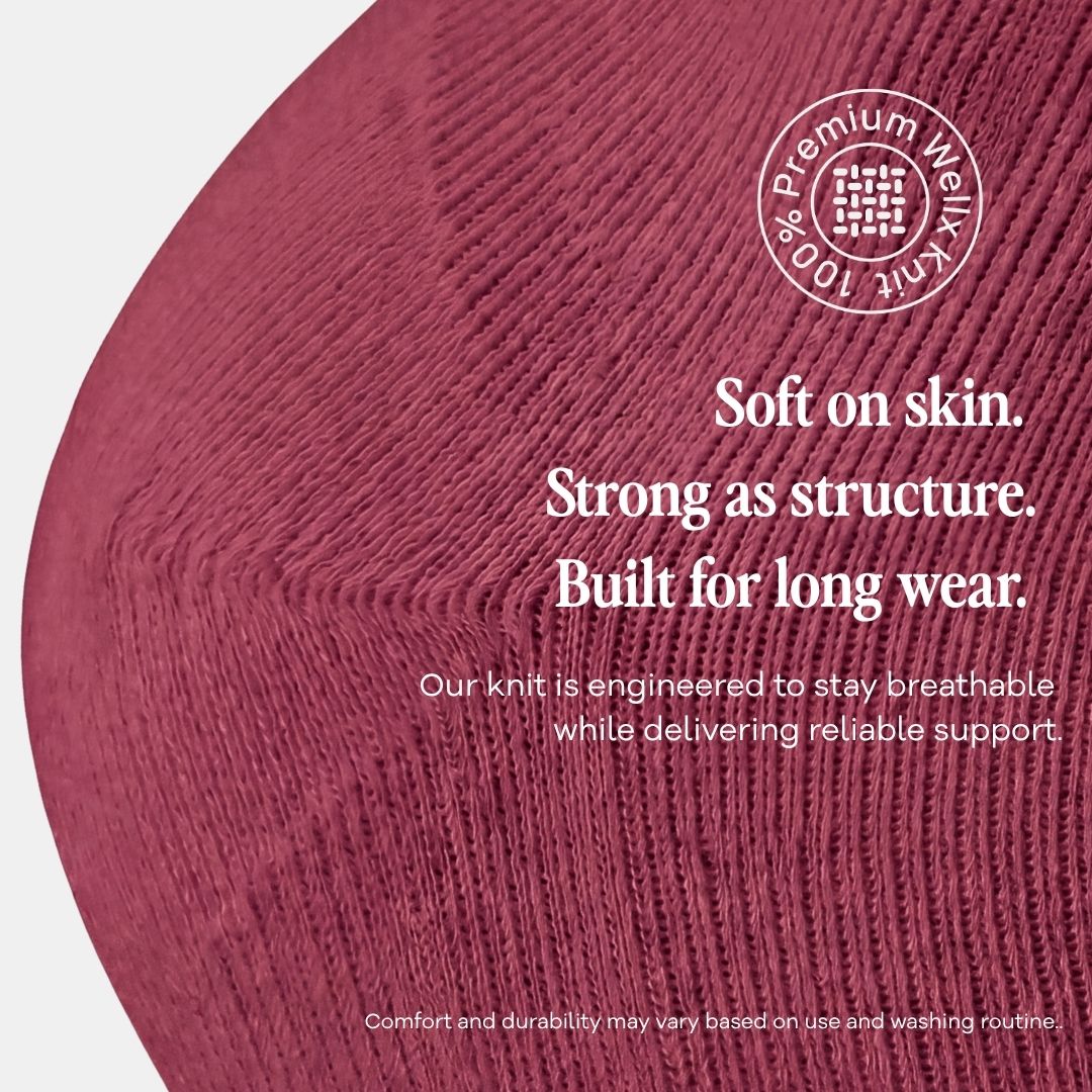 Burgundy Compression Socks For Men, A close-up of a textured knit fabric in a dusty rose or mauve pink color, with white text overlays describing its softness, strength, and breathability. A circular badge in the top right reads 'Premium Waffle 100% Waffle Knit'.